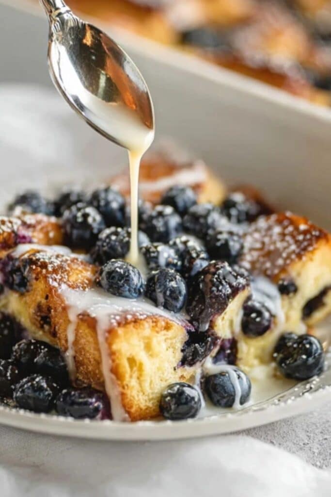 Blueberry French Toast Casserole with Vanilla Glaze served on rustic table