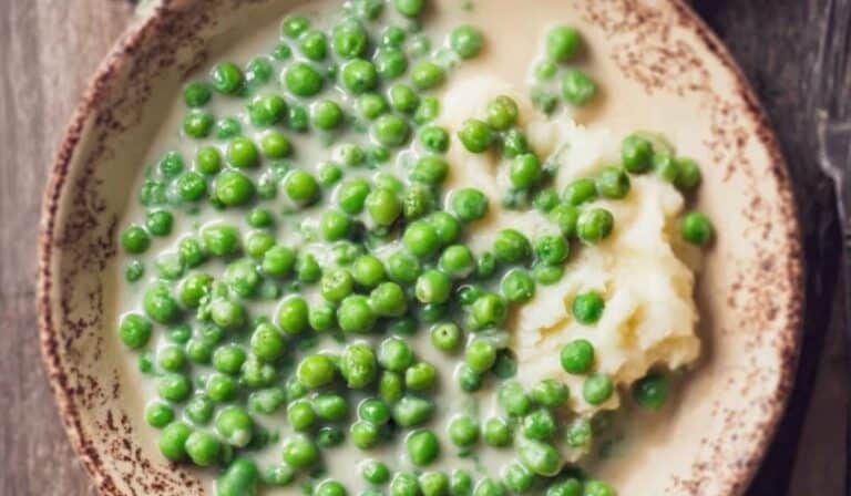 Old Fashioned Creamed Peas served in a rustic bowl