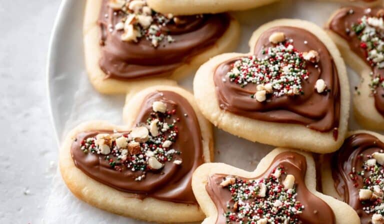 Cream Cheese Cut-Out Cookies with Nutella Glaze on holiday plate