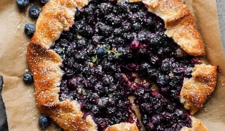 Blueberry Galette on parchment with golden crust