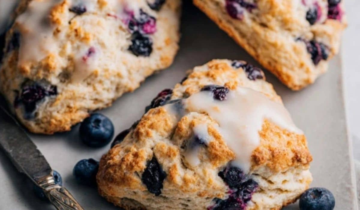 Freshly baked blueberry scones on a rustic breakfast table