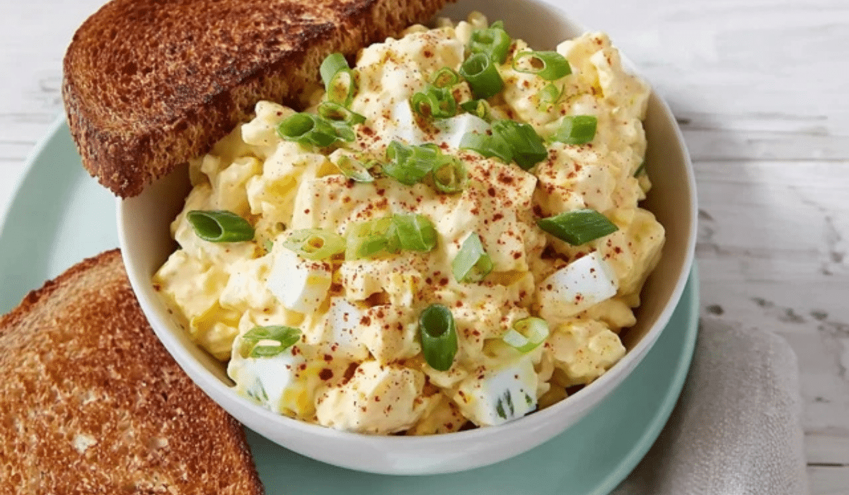 Delicious Egg Salad in a bowl with paprika and green onions