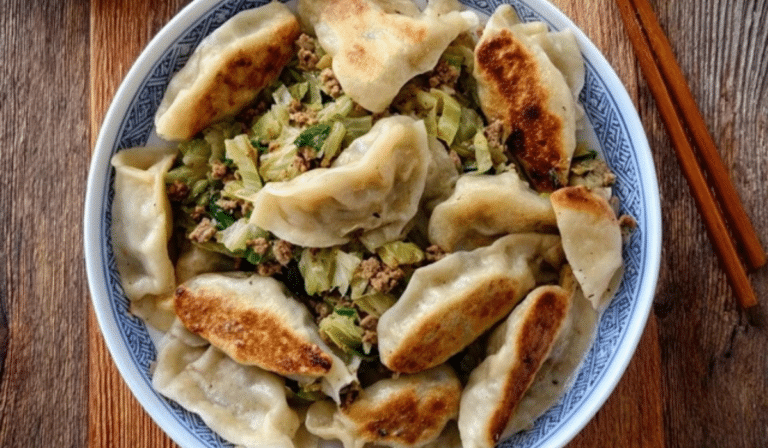 Dumpling cabbage filling in a bowl with pork, napa cabbage, and scallions