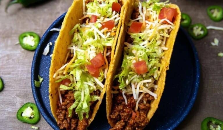 Rotel tacos with cheesy beef filling, lettuce, and jalapeños