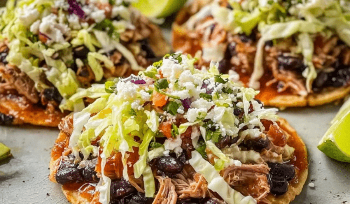 Slow Cooker Pork and Black Bean Tostadas topped with lettuce and cheese