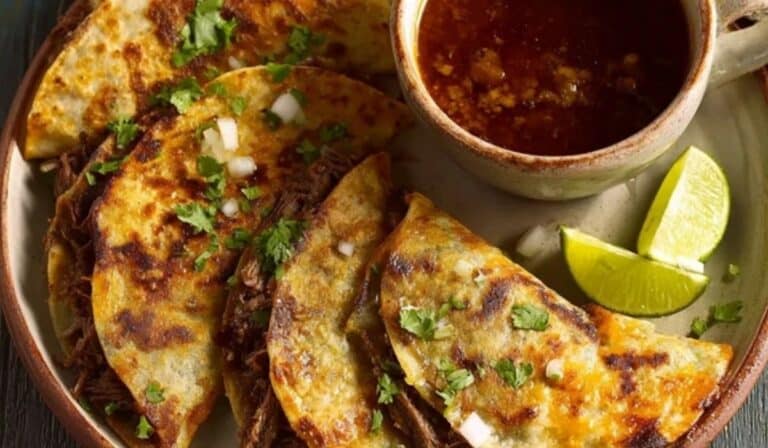 Quesabirria Tacos with melty cheese and consomé for dipping