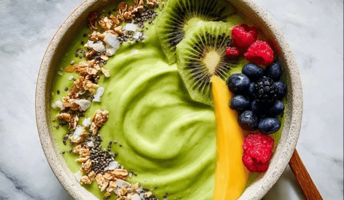 Detox Green Smoothie Bowl topped with kiwi, berries, granola, and chia seeds