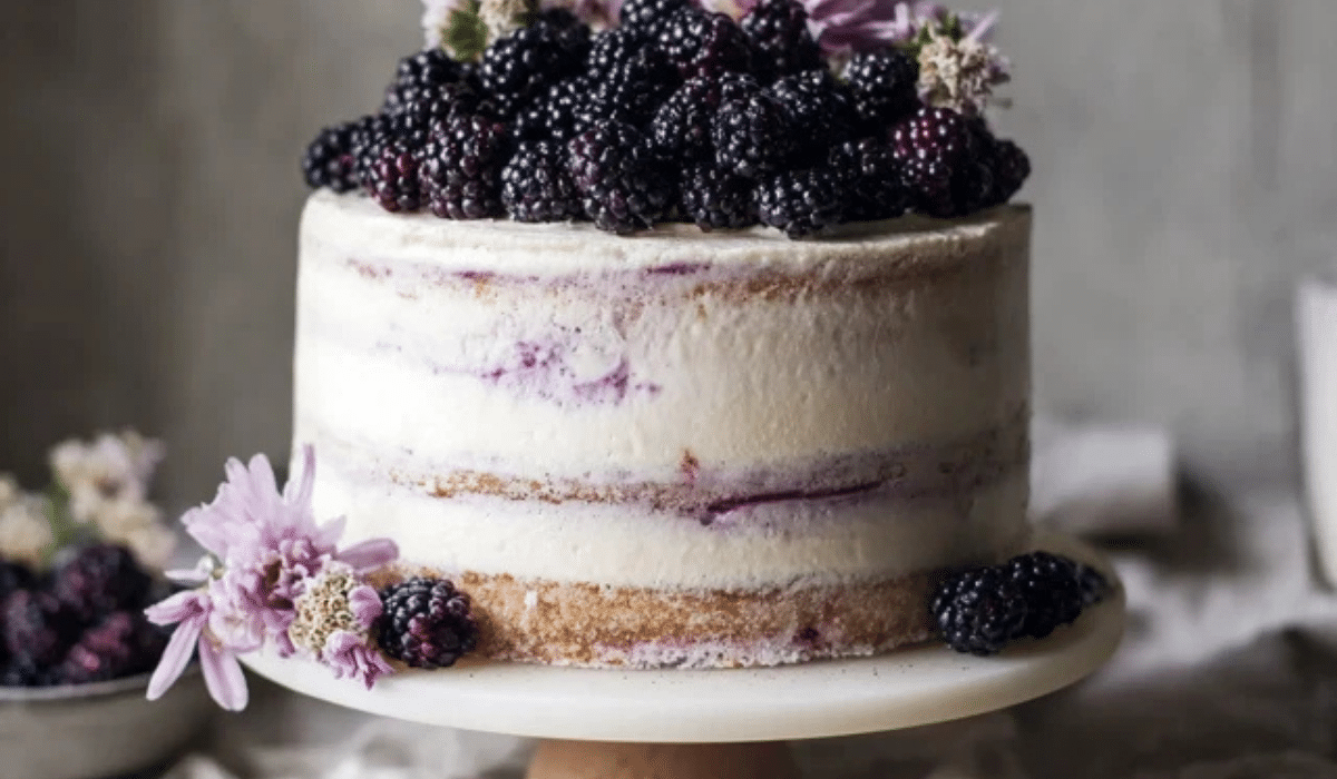 Blackberry Lavender Naked Cake with fresh berries and semi-naked frosting