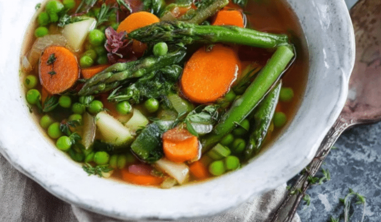 Spring Vegetable Soup with asparagus, peas, herbs, and lemon in a bright brothy bowl