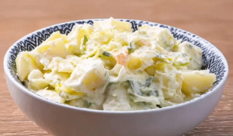 Creamy Potato Coleslaw in a bowl with potatoes and cabbage