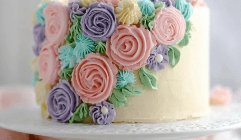 : Buttercream flower cake with pastel piped roses and leaves